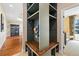 Mud room with custom built-in storage, coat hooks, bench seating and is adjacent to the entry and a carpeted room at 17452 W 83Rd Pl, Arvada, CO 80007