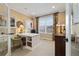 Bright home office featuring built-in shelving, a white desk, and a comfortable chair at 17452 W 83Rd Pl, Arvada, CO 80007