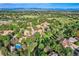 An aerial view of this community highlights lush landscaping, winding roads, and a neighborhood pool at 2299 Ranch Dr, Westminster, CO 80234