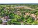 Aerial view of a community with mature trees, green spaces, and nearby equestrian facilities at 2299 Ranch Dr, Westminster, CO 80234