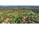 Scenic aerial view of a community with a golf course, ponds, and mountain backdrop at 2299 Ranch Dr, Westminster, CO 80234