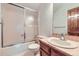 Bathroom featuring a shower and tub combination with tiled walls and a single sink vanity at 2299 Ranch Dr, Westminster, CO 80234