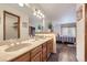The bathroom boasts double sinks, wood cabinets, and access to the bedroom at 2299 Ranch Dr, Westminster, CO 80234