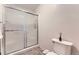 This bathroom features a glass door for the shower, and a white toilet, creating a simple and clean aesthetic at 2299 Ranch Dr, Westminster, CO 80234