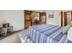 Spacious bedroom showcasing an open doorway, side table, and neutral carpet at 2299 Ranch Dr, Westminster, CO 80234