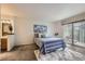 Relaxing bedroom with a blue striped comforter, modern art, and access to a patio at 2299 Ranch Dr, Westminster, CO 80234