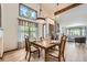 Sunlit dining room with a table set for dinner and views into the living room at 2299 Ranch Dr, Westminster, CO 80234