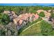 An exterior view of a home shows it is surrounded by lush trees and a large green lawn at 2299 Ranch Dr, Westminster, CO 80234