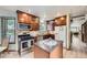 Well-equipped kitchen featuring modern appliances, wooden cabinetry, and a center island at 2299 Ranch Dr, Westminster, CO 80234