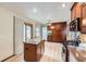 Well-appointed kitchen featuring an island and plenty of dark wood cabinets at 2299 Ranch Dr, Westminster, CO 80234