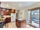 This kitchen features wood cabinets, laminate floors, and a kitchen island at 2299 Ranch Dr, Westminster, CO 80234