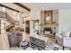 Welcoming living room with brick fireplace, wood accents, and stairs to the second floor at 2299 Ranch Dr, Westminster, CO 80234