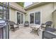 Cozy patio with stone flooring, wicker furniture, and multiple access points to the home at 2299 Ranch Dr, Westminster, CO 80234