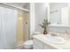 Bathroom featuring a shower and vanity with a decorative mirror at 7484 E Princeton Ave, Denver, CO 80237