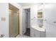 Bathroom featuring a shower with a gold-framed door and a vanity with a white sink at 7484 E Princeton Ave, Denver, CO 80237