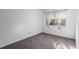 Bright bedroom featuring a large window with sheer curtains and neutral carpet at 7484 E Princeton Ave, Denver, CO 80237