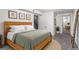 Bedroom featuring a wooden bedframe, beige carpet, and a sliding glass door at 7484 E Princeton Ave, Denver, CO 80237