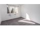 Empty bedroom with carpet flooring, a large window, and white walls at 7484 E Princeton Ave, Denver, CO 80237