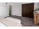 Bedroom with a large closet, door to the hallway, and carpet floors at 7484 E Princeton Ave, Denver, CO 80237