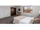 Bedroom with a console table, closet, large window, and carpet floors at 7484 E Princeton Ave, Denver, CO 80237
