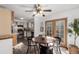Bright dining area adjacent to the kitchen, featuring a ceiling fan and outdoor views at 7484 E Princeton Ave, Denver, CO 80237
