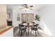 Sunlit dining area showcasing charming light fixture, and easy access to the kitchen at 7484 E Princeton Ave, Denver, CO 80237