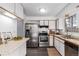 Efficient kitchen showcasing modern appliances, ample counter space, and neutral color scheme at 7484 E Princeton Ave, Denver, CO 80237