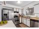 Functional kitchen featuring stainless steel appliances, white cabinets, and efficient layout at 7484 E Princeton Ave, Denver, CO 80237