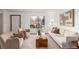 Inviting living room offering ample natural light, contemporary furnishings, and a serene atmosphere at 7484 E Princeton Ave, Denver, CO 80237