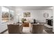 Bright living room showcasing a neutral palette, large window, and comfortable seating arrangement at 7484 E Princeton Ave, Denver, CO 80237