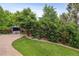 Lush backyard with green lawn, mature trees, stamped concrete patio, and a hot tub beneath a gazebo at 26155 E Euclid Dr, Aurora, CO 80016