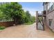 Backyard with a concrete patio, lawn area, mature trees, and stairs leading to a deck at 26155 E Euclid Dr, Aurora, CO 80016