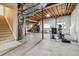 Unfinished basement area with water heater, fitness equipment, and access to the home's upper floors at 26155 E Euclid Dr, Aurora, CO 80016