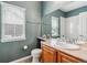 Bathroom with a vanity, toilet, and a mirror, all illuminated by natural light from the window at 26155 E Euclid Dr, Aurora, CO 80016