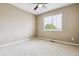 This bedroom has neutral walls, light carpeting, and a window providing natural light at 26155 E Euclid Dr, Aurora, CO 80016