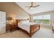 Comfortable bedroom with peaked ceiling, ceiling fan, and scenic window view at 26155 E Euclid Dr, Aurora, CO 80016