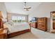 Relaxing bedroom featuring vaulted ceilings, ceiling fan, and bright window at 26155 E Euclid Dr, Aurora, CO 80016