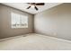 Bedroom with neutral walls, light carpeting, and a window providing natural light at 26155 E Euclid Dr, Aurora, CO 80016