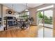 Bright dining area with wood floors, fireplace, and sliding door to outdoor deck at 26155 E Euclid Dr, Aurora, CO 80016