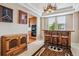 Stylish dining area with a unique antler chandelier and rustic wooden bar with seating at 26155 E Euclid Dr, Aurora, CO 80016