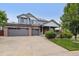 Inviting two-story home with brick accents, covered porch, and a three-car garage at 26155 E Euclid Dr, Aurora, CO 80016