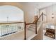 Upstairs hallway landing with views to rooms below and stairs to other floors at 26155 E Euclid Dr, Aurora, CO 80016