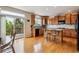 Well-lit kitchen featuring an island, wooden cabinets, and access to an outdoor balcony at 26155 E Euclid Dr, Aurora, CO 80016