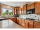 Well-lit kitchen features wood cabinets, gas cooktop, and decorative backsplash at 26155 E Euclid Dr, Aurora, CO 80016