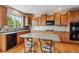 Bright kitchen with a kitchen island, lots of counter space, and modern appliances at 26155 E Euclid Dr, Aurora, CO 80016
