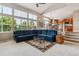 Bright living room features large windows, vaulted ceilings, and a comfortable blue sectional sofa at 26155 E Euclid Dr, Aurora, CO 80016