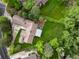 Aerial view of a home with a well-maintained lawn, mature trees, patio, and a neatly paved driveway at 1 Club Ln, Littleton, CO 80123