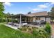 A beautiful backyard with a covered patio, outdoor seating, grill, and lush landscaping, perfect for outdoor entertainment at 1 Club Ln, Littleton, CO 80123