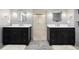Dual vanity bathroom featuring marble counters, modern fixtures, and decorative mirrors at 1 Club Ln, Littleton, CO 80123