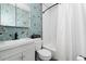 Bathroom with floral wallpaper, new vanity, and shower/tub combo at 1 Club Ln, Littleton, CO 80123